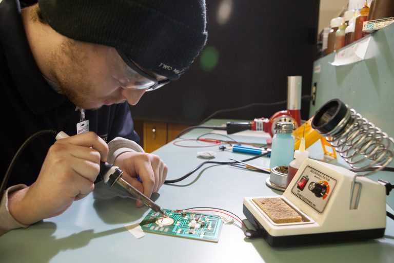 Avionics Technician Student Soldering Circuit board