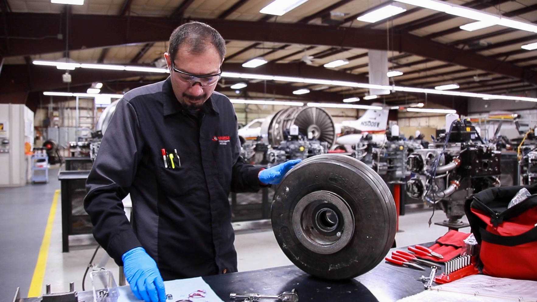 Spartan College student working with tire components