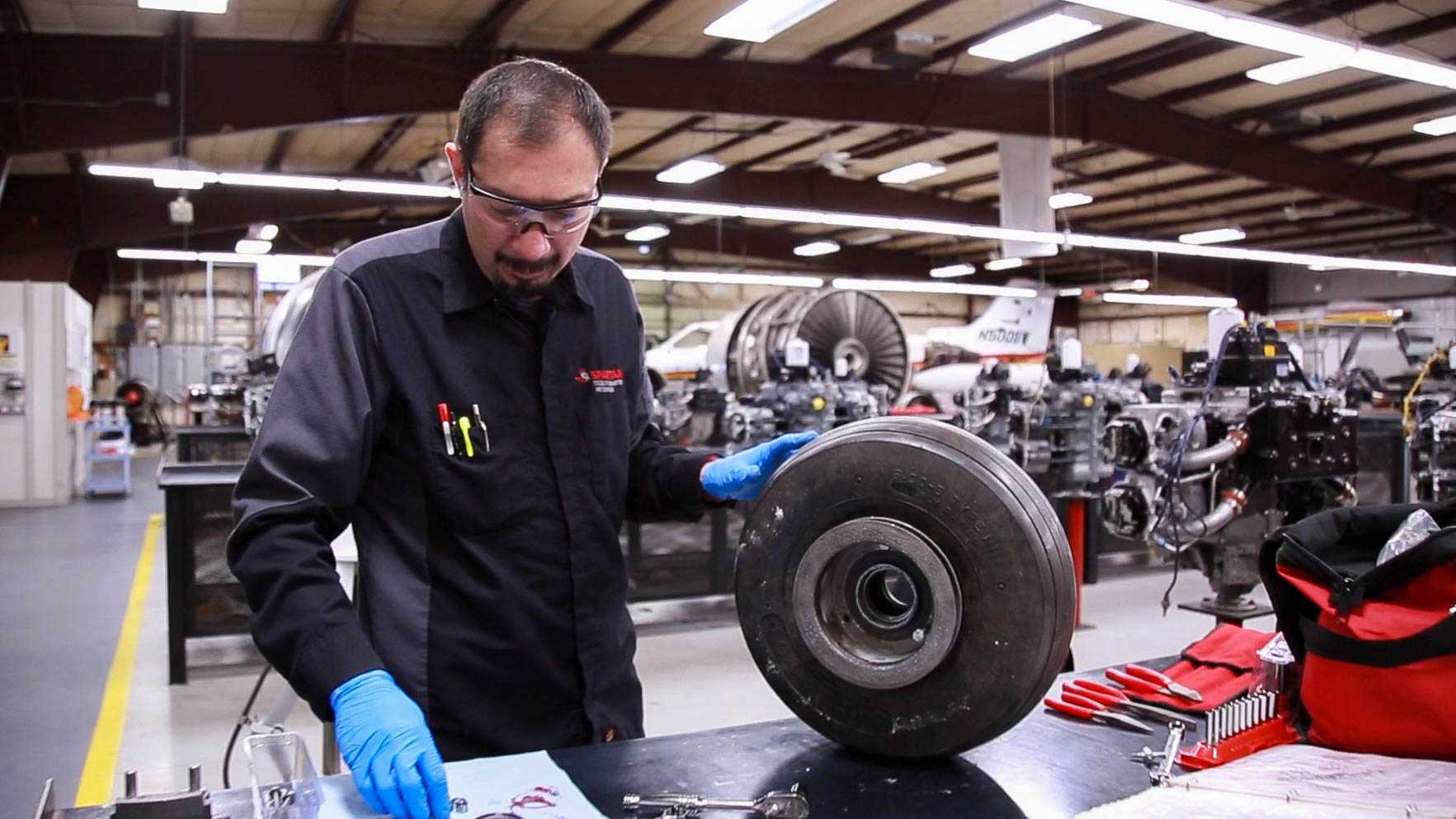 Spartan College student working with tire components