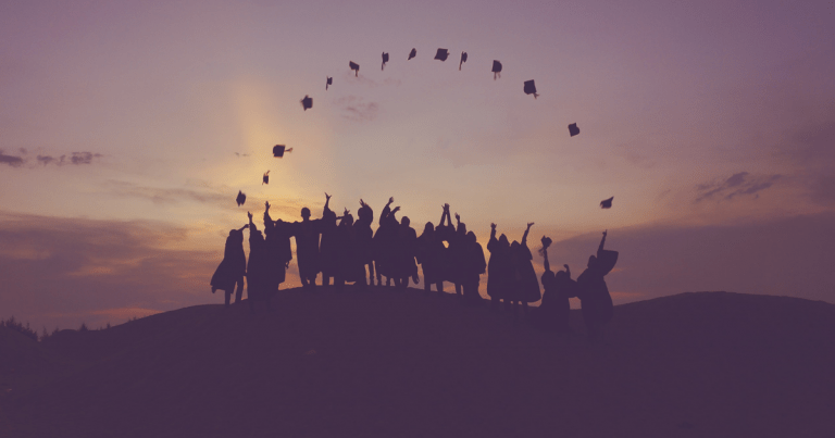 graduation photo with caps in the air