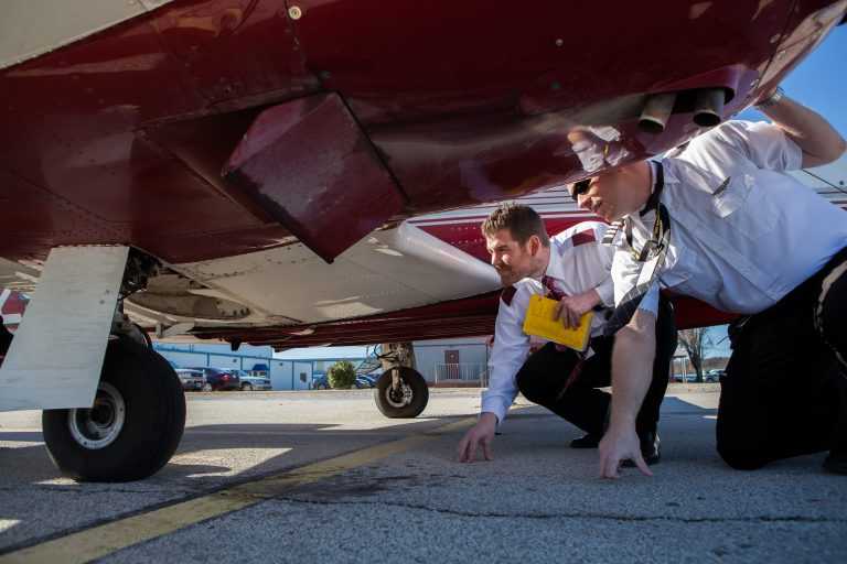 Students Inspecting Plane | Spartan College of Aeronautics and Technology