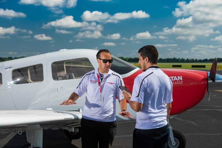 flight instructor with student in front of plane