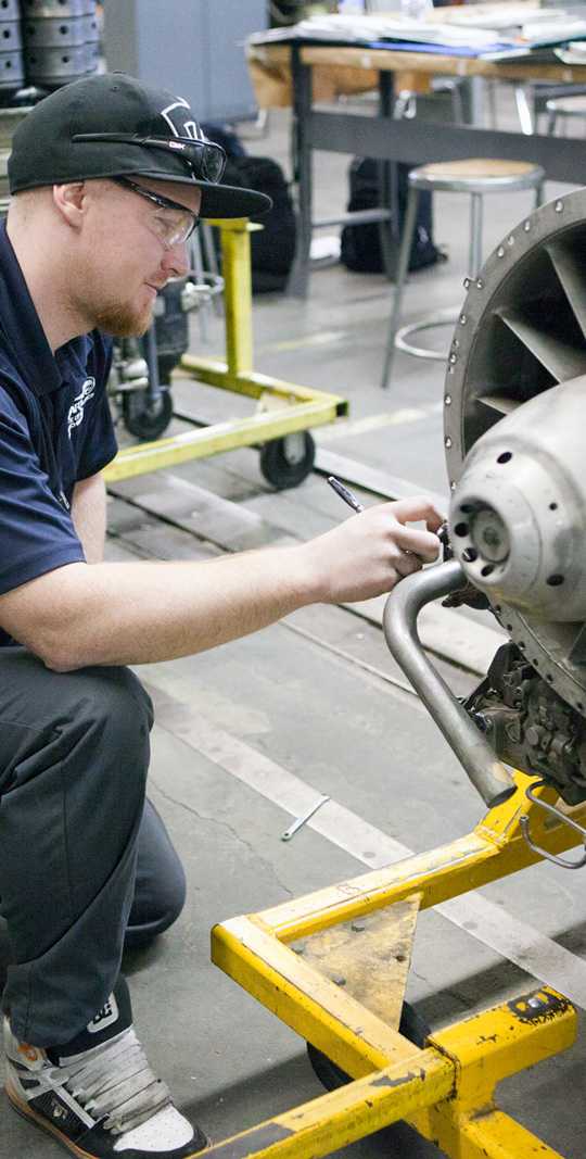 Guy Working on Engine Spartan College