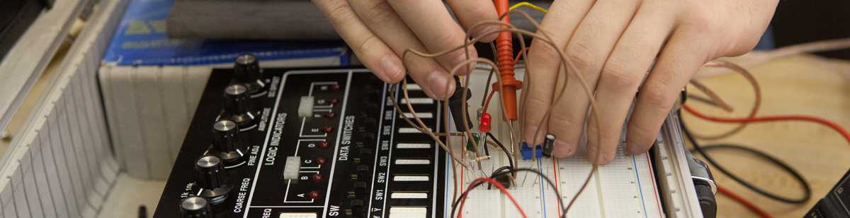 aet student working on a breadboard