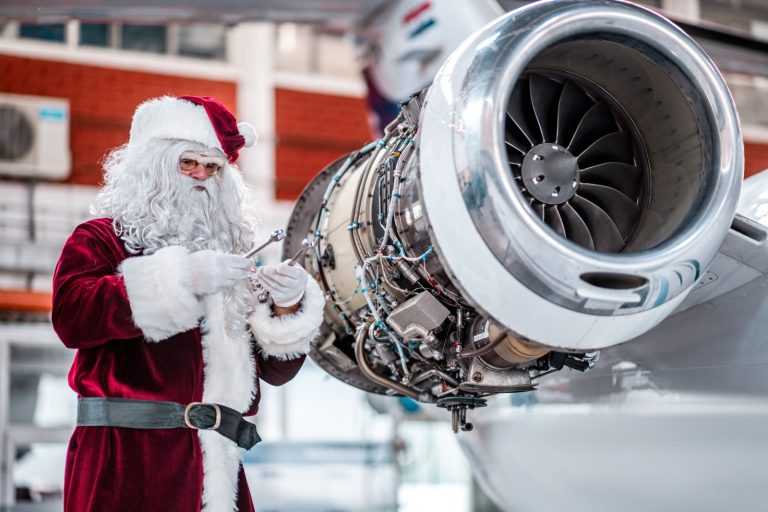 Santa Claus maintains the jet engine before the flight