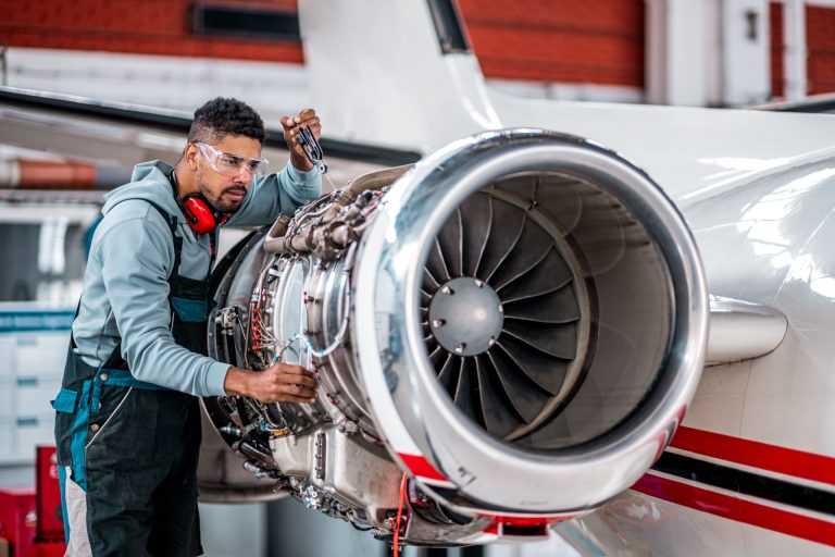 Aircraft Mechanic checking jet engine of the airplane