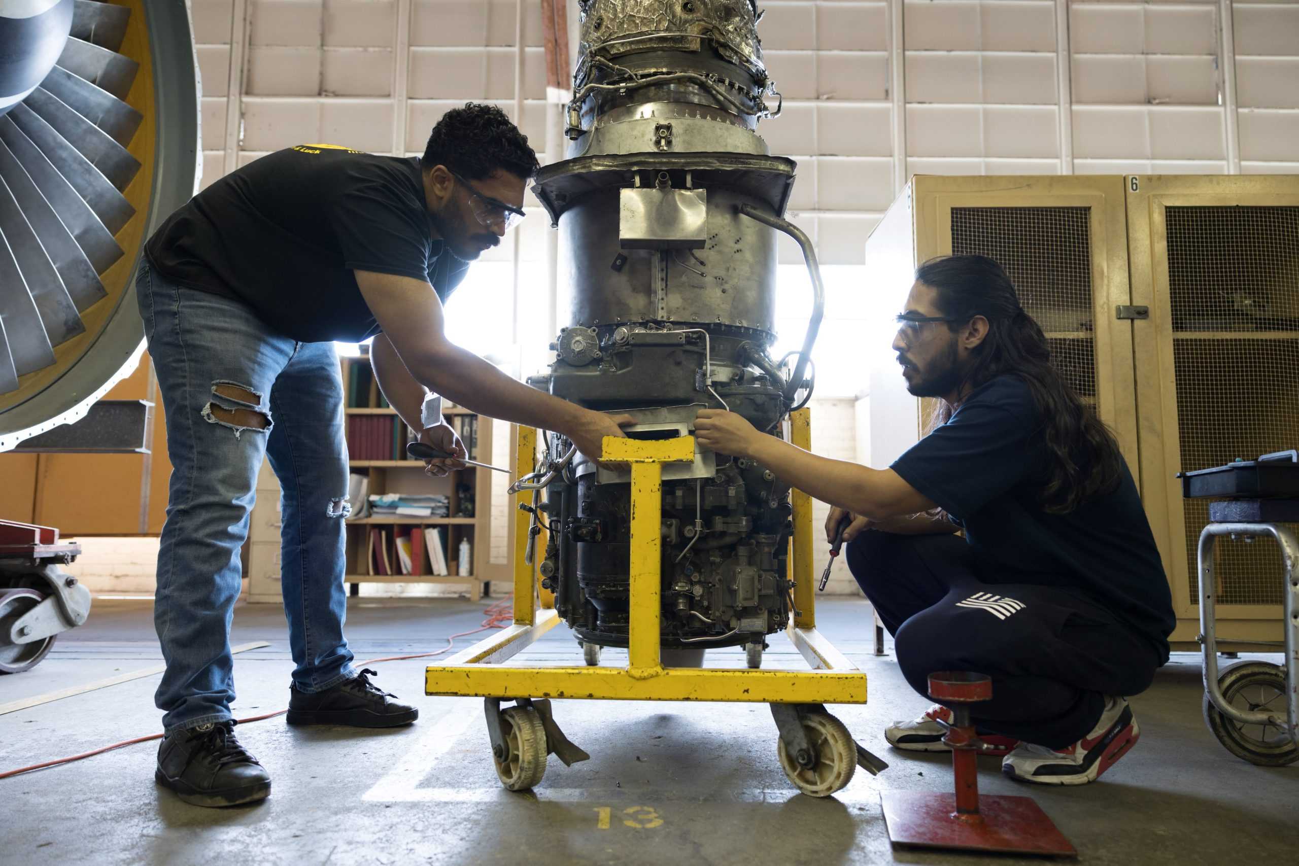 AMT students working on examining turbine engine