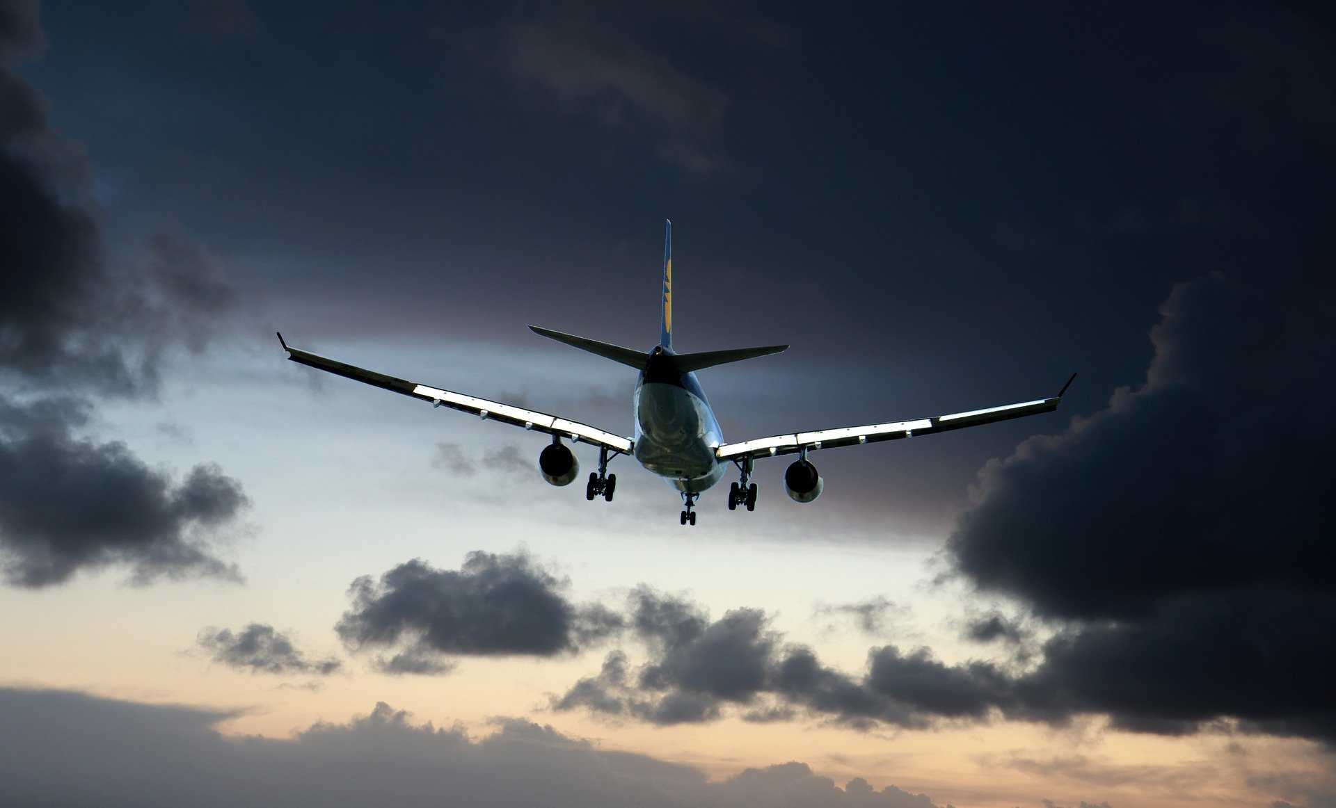 plane in flight with dark clouds