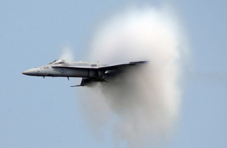 plane going supersonic with air pushing out from the sides