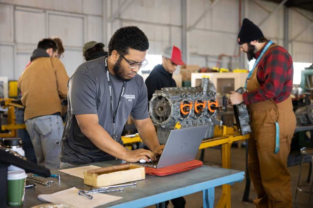 AMT student working with laptop