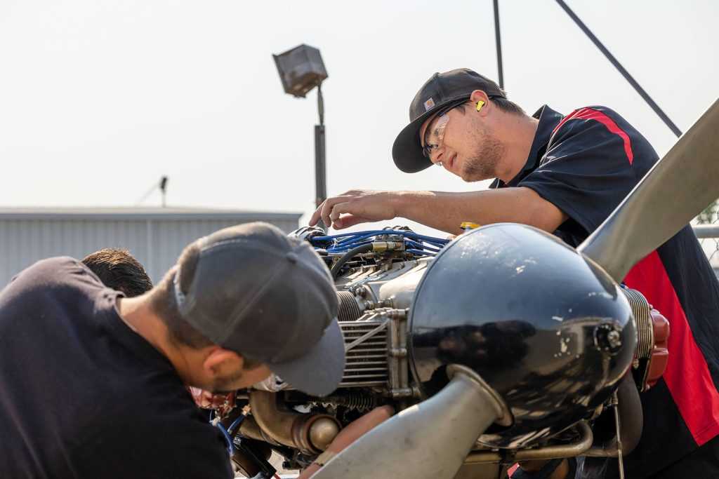 spartan students working on plane engine