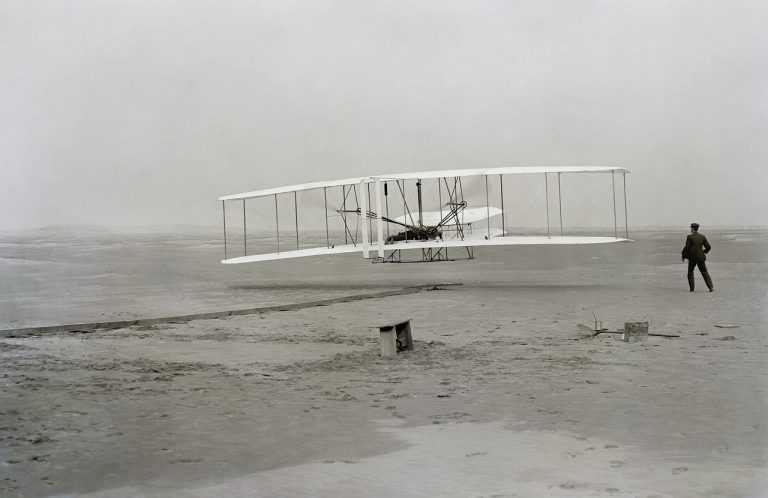 wright brothers plane in grayscale