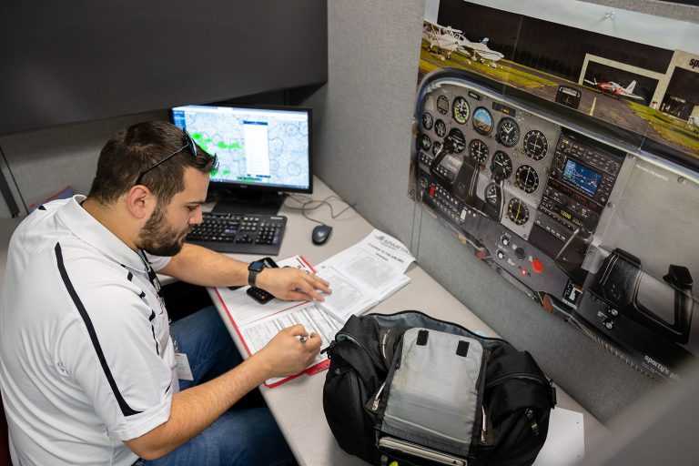spartan instructor in cubicle working setting up flight plan