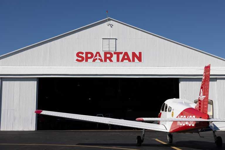 spartan hangar with plane sitting outside