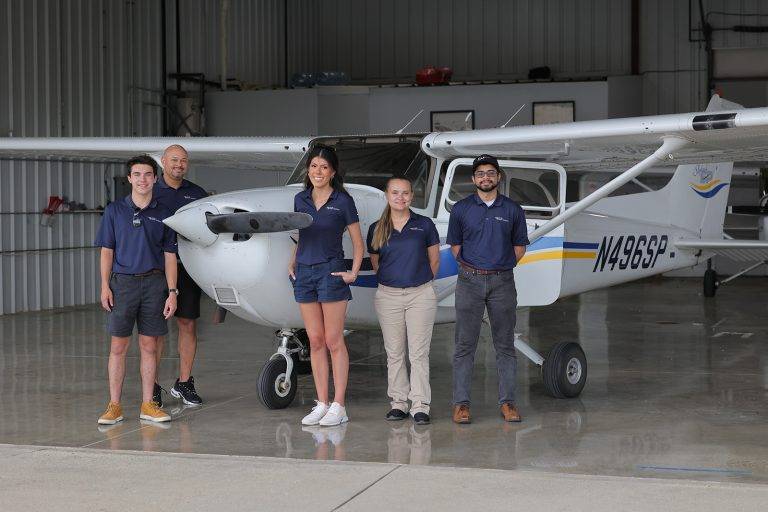 atlas cadet students in front of plane