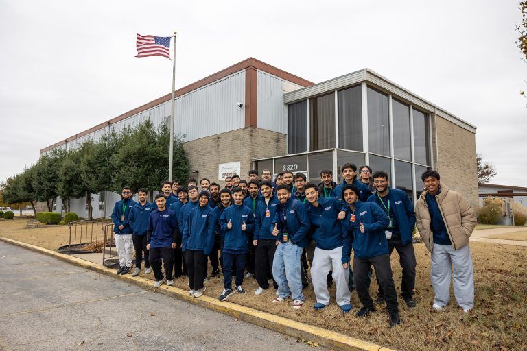 new students from saudia technic arrive at spartan college taking a group shot outside campus