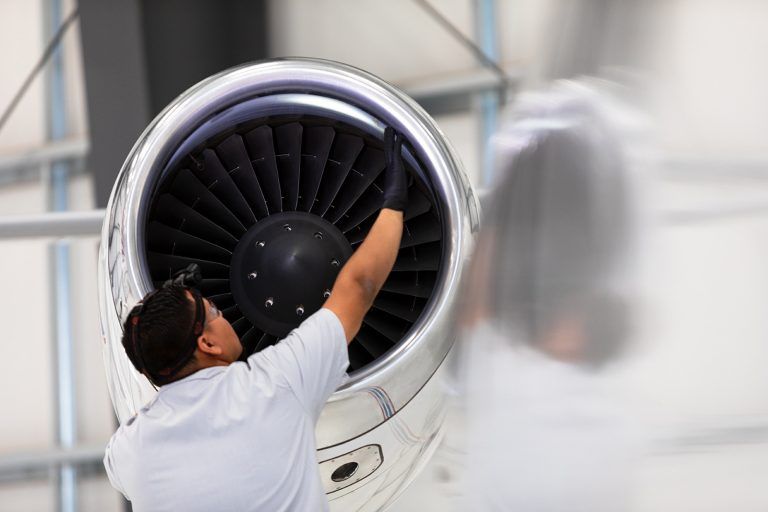 aviation maintenance worker inspecting turbine