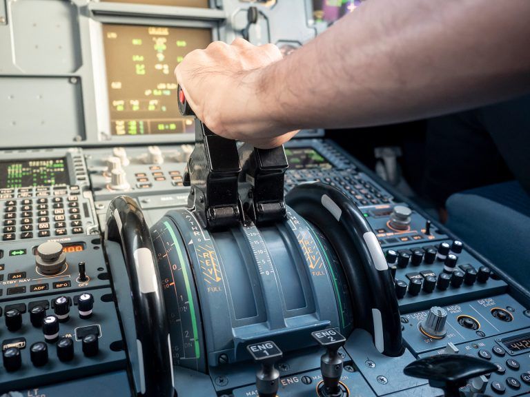 pilot using the airplane throttle in cockpit